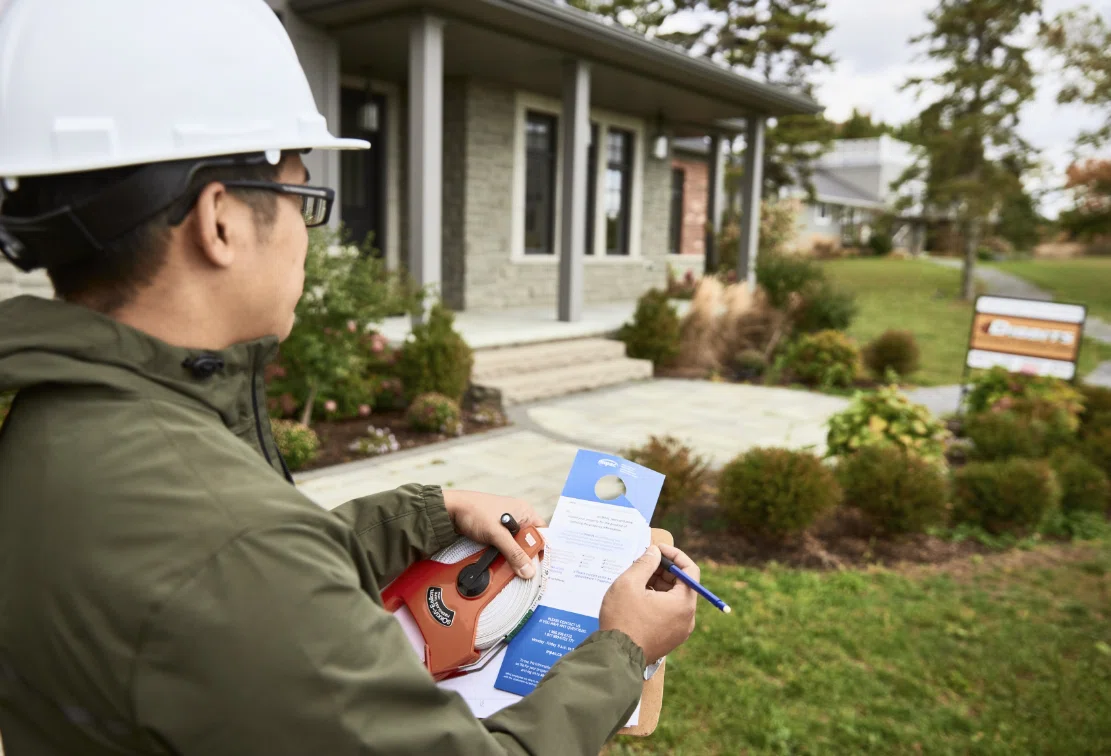 image of a property inspector outside a house